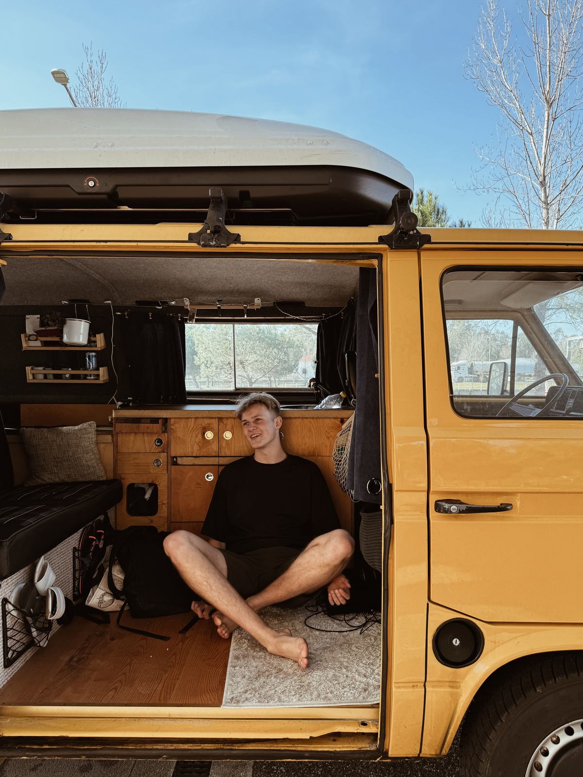 Sitting in the open door of a Birbi van